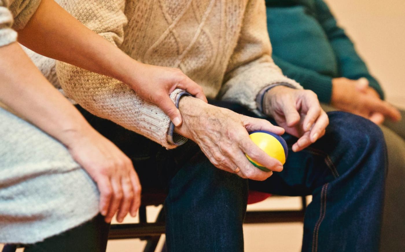 Elderly person holding a stress ball